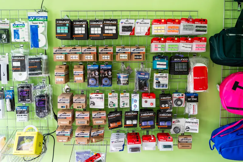 Overgrips, replacement grips and dampeners from Yonex, Head, Babolat, Tecnifibre, Gamma, Solinco, Wilson, Tourna and Diadem on the accessories wall