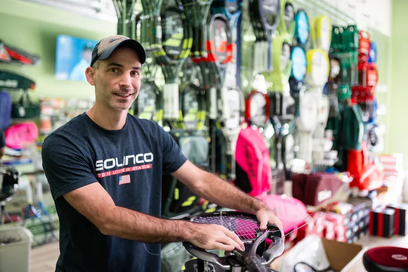 Mark Kuczynski at the stringing machine in URacquet Shop